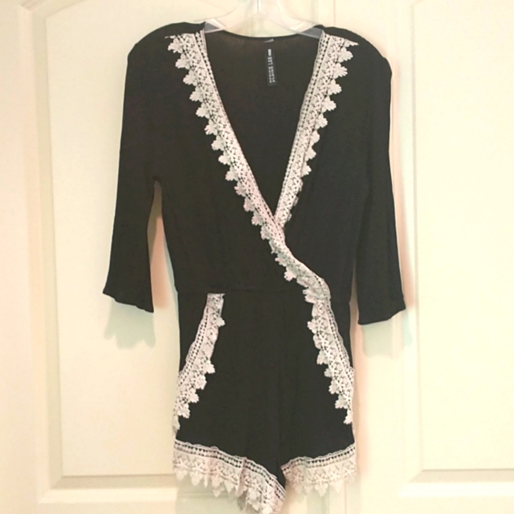 Crinkle romper with crochet trim. Black .size M